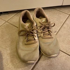 Gold Nike shoes.